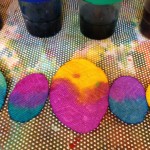 Mixing liquid watercolor onto egg shapes
