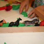 Green play dough and animals